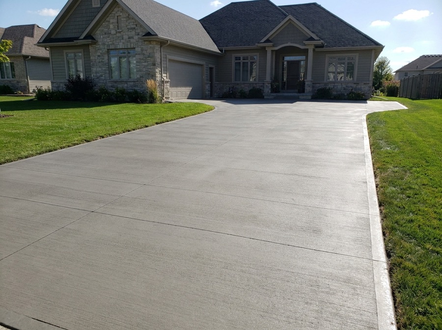 New concrete driveway with a broom finish at a Winnipeg home
